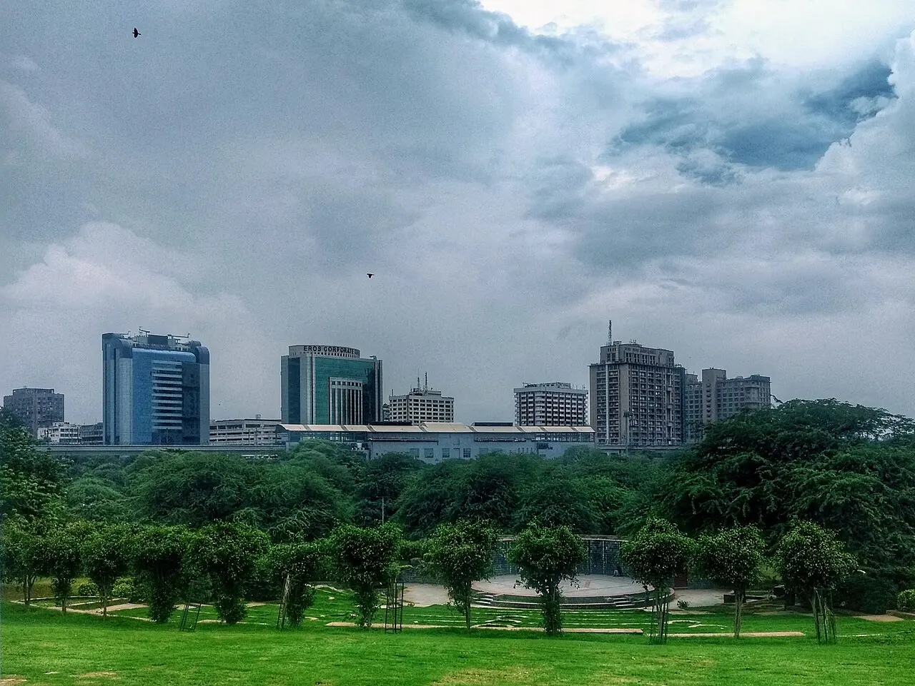 A modern city skyline beneath a cloudy sky