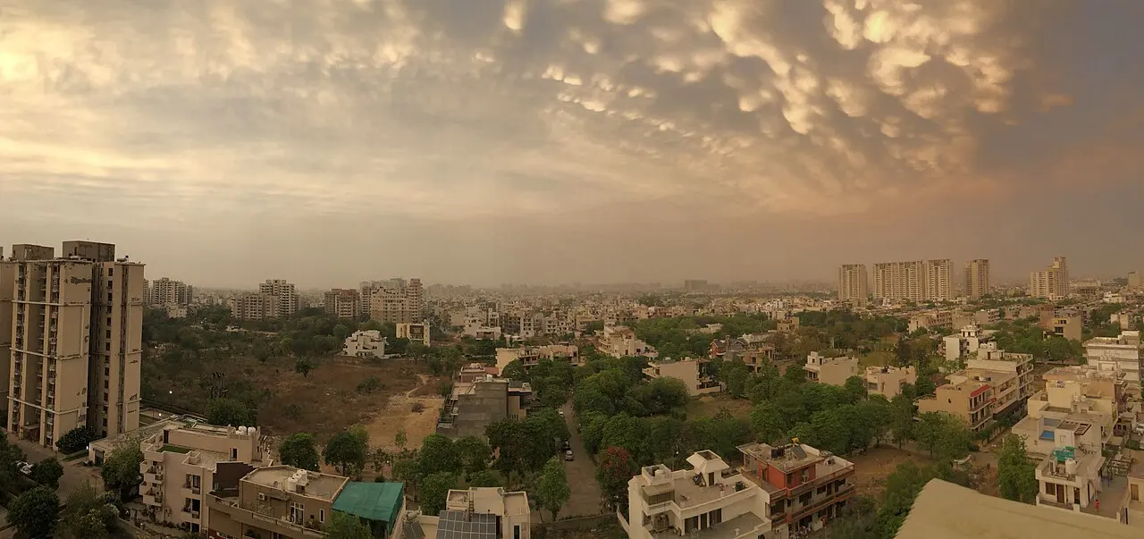 A city panorama at dusk beneath a dramatic sky