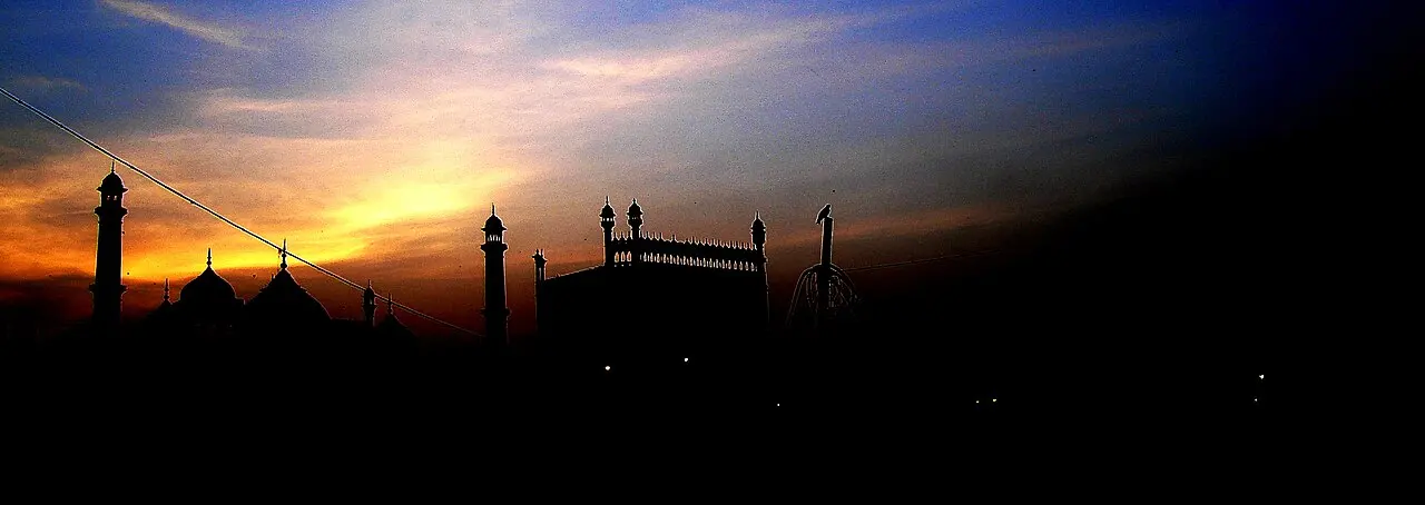 A historic skyline silhouetted against the setting sun