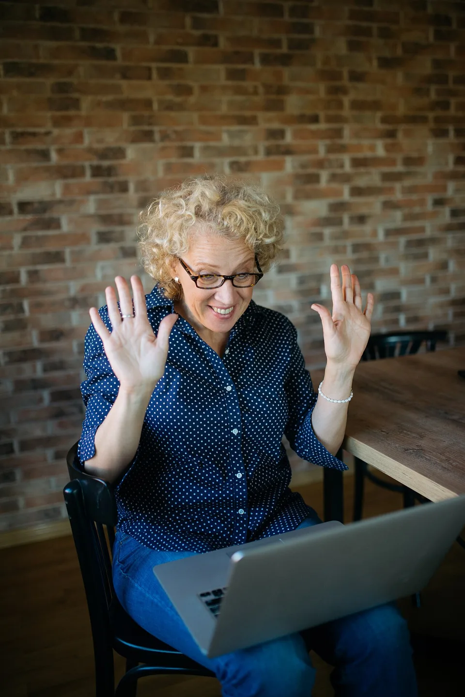 Adult woman smiling during a laptop video call